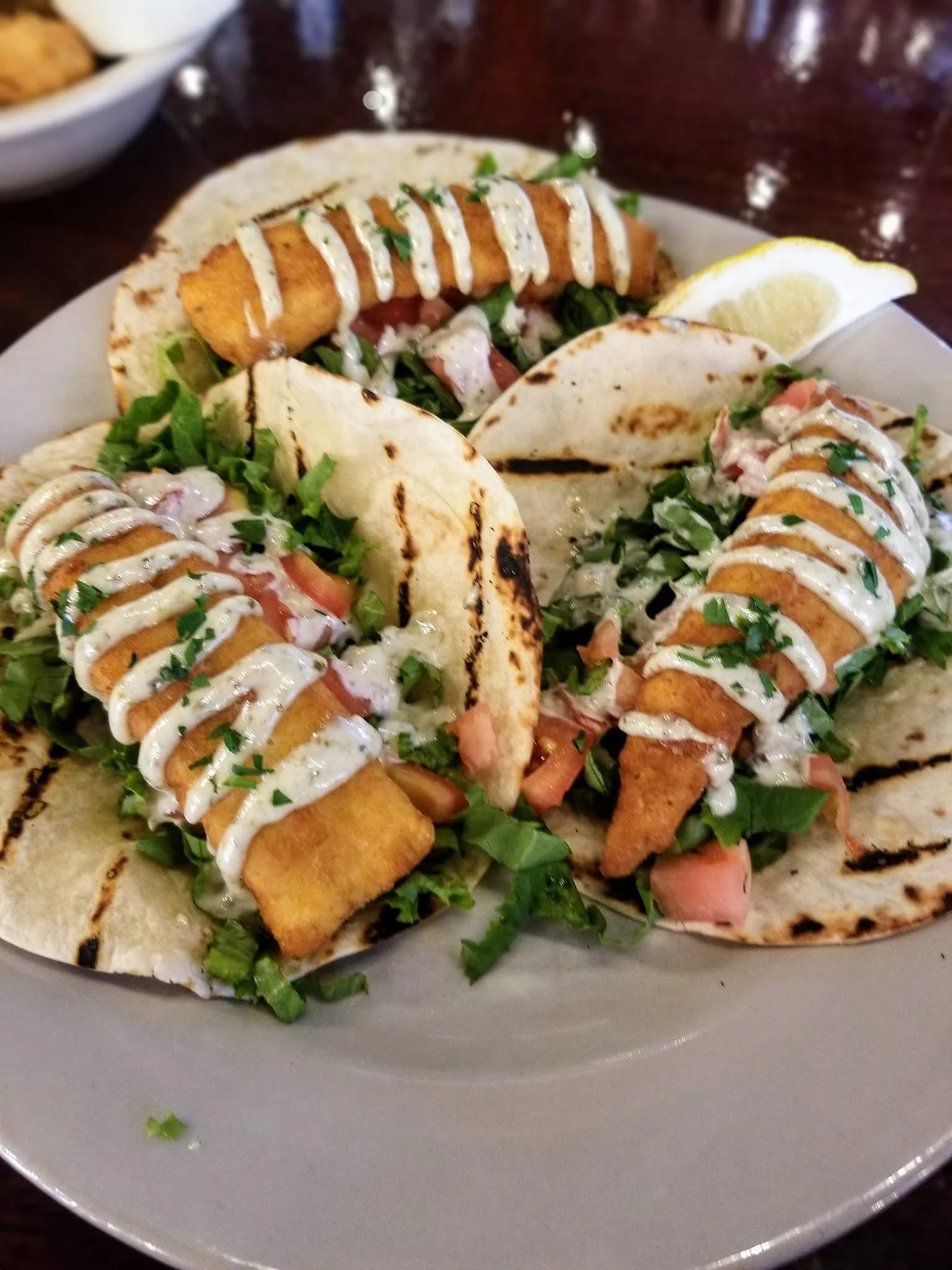 A delicious perfectly cooked fresh haddock lunch special with a scrumptious aïoli drizzle at the Waterworks restaurant in Rockland Maine
