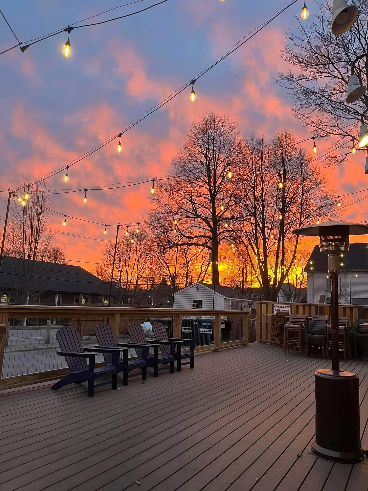 a gorgeous sunset view on our patio under the beautiful ambience of our lighting with a cozy outdoor heater at the Waterworks restaurant in Rockland, Maine
