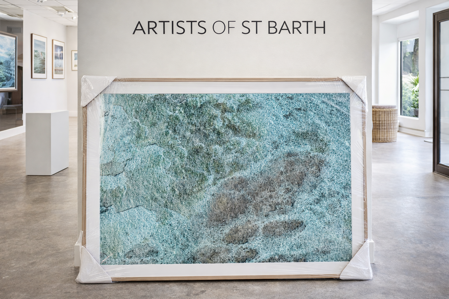 A framed abstract artwork titled 'Artists of St Barth' displayed in an art gallery with other framed works on the wall and a television in the background.