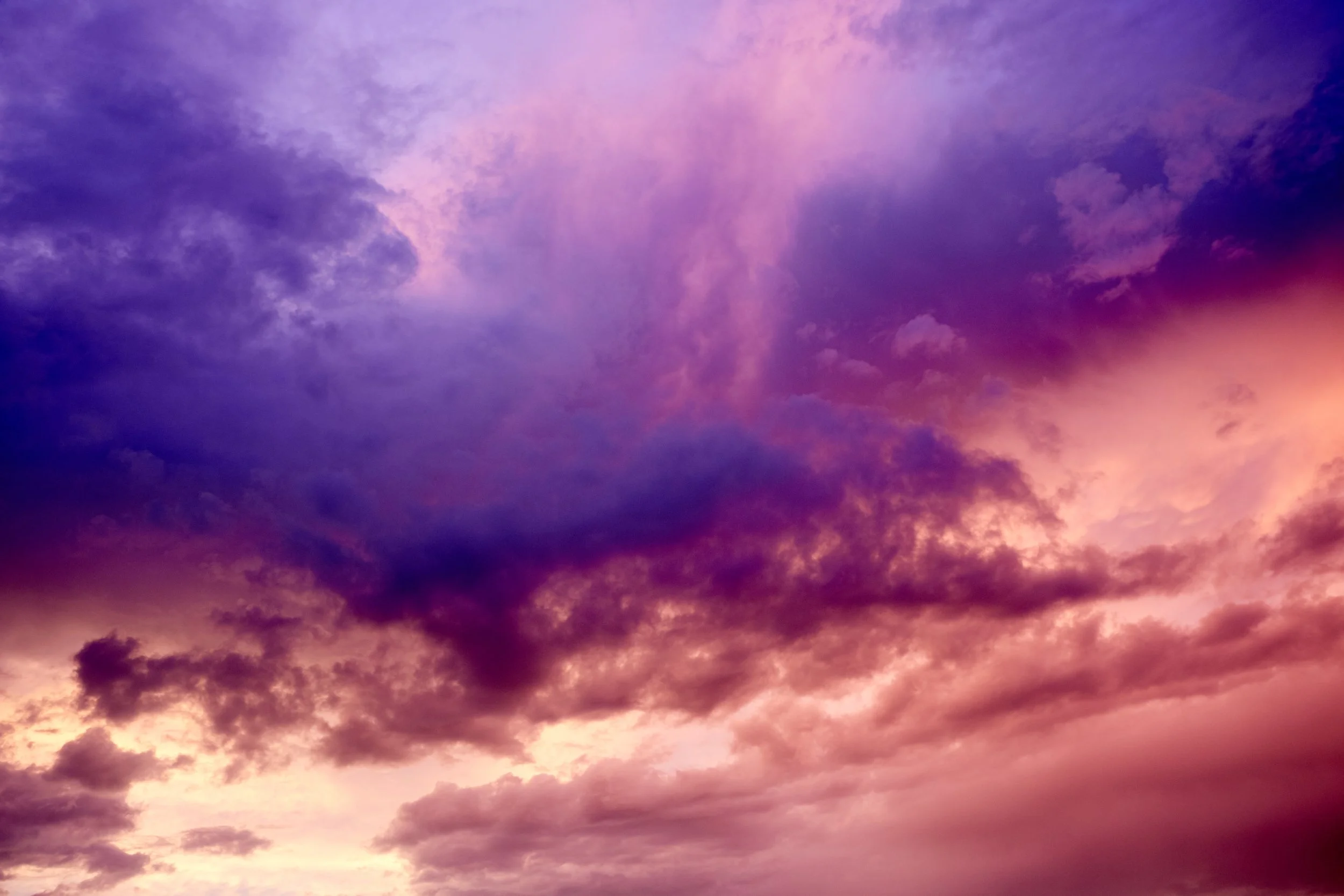Colorful sky with purple, pink, and blue clouds at sunset.