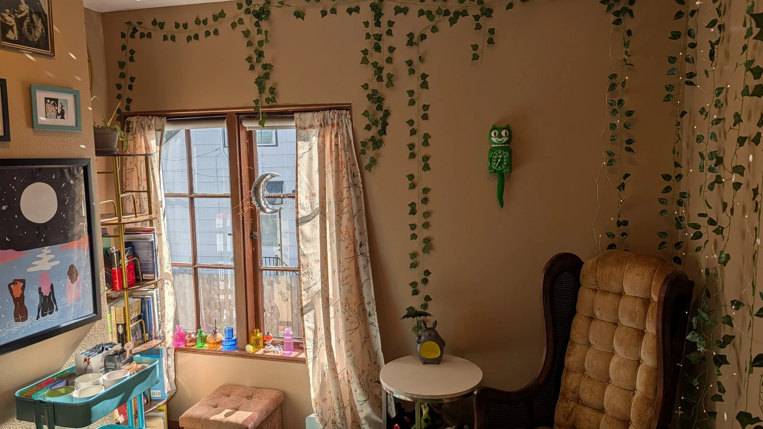 window with cat clock and vines in a therapy office space