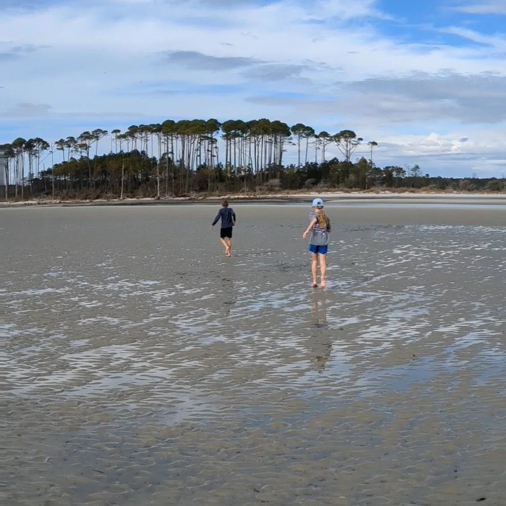 Kids running through the water at The Point.