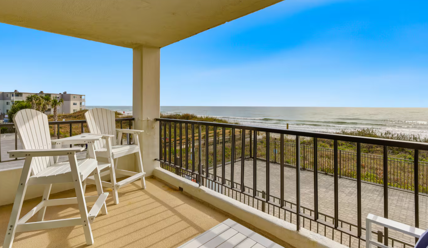 Take in the sunset from our elevated white Adirondack chairs. These "bar-height" chairs are designed to provide a clear view over the railing, ensuring you never miss a moment of the oceanfront scenery and coastal breeze.
