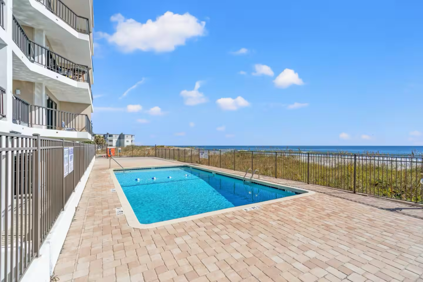 Dive into crystal-clear waters at your oceanfront retreat! This sparkling pool beckons you for refreshing morning swims while you soak up endless sunshine from your private balcony above.

