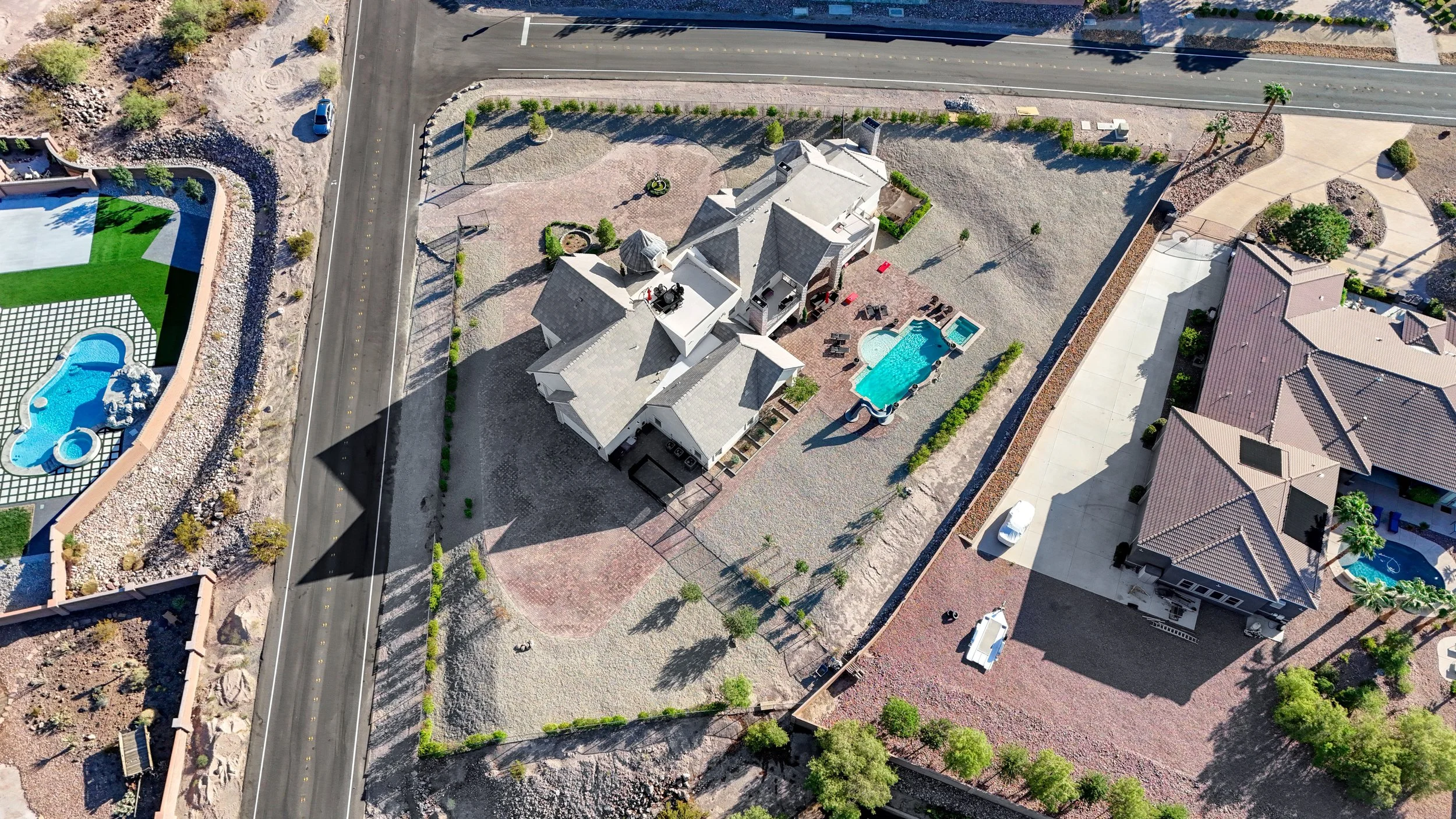 Aerial view of The Castle private estate on a corner lot over one acre in an exclusive Henderson neighborhood, showcasing the pool, spa, courtyard, and expansive grounds