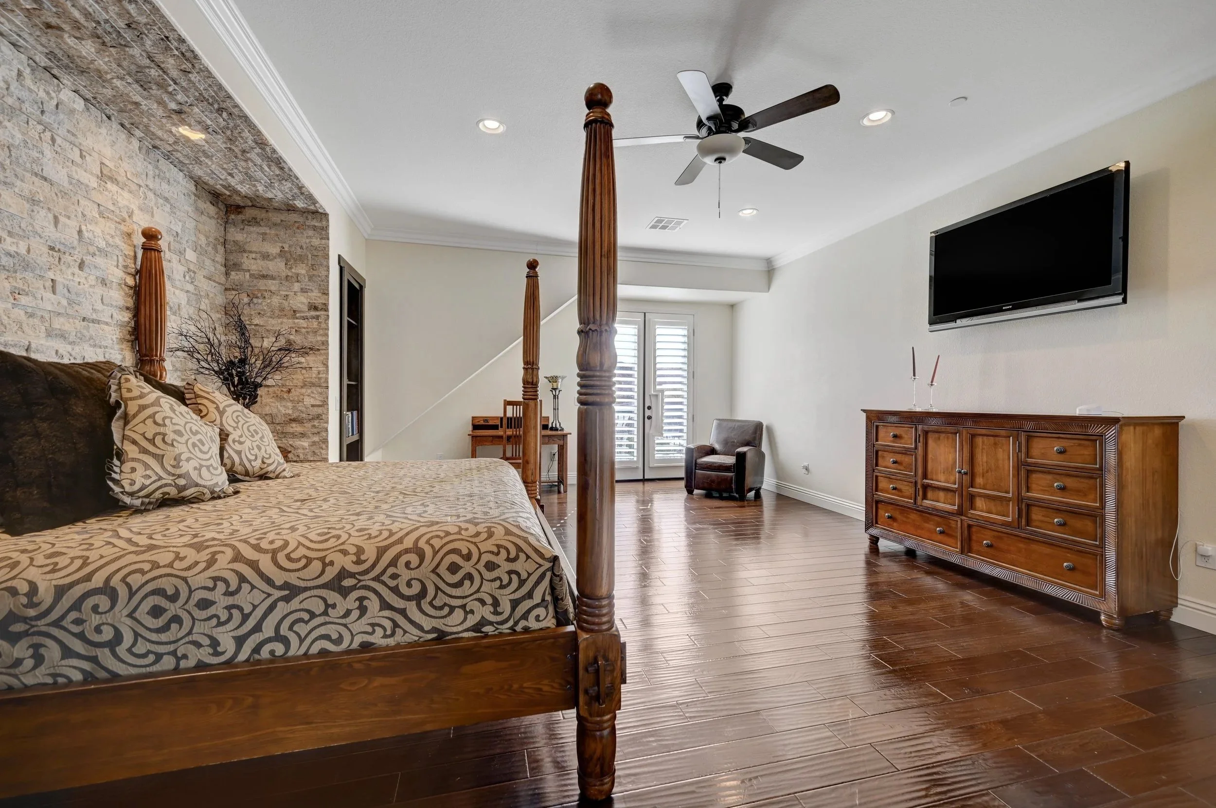 Primary suite with king bed, double balconies overlooking the Las Vegas Strip and mountains, and en-suite access to a private library at The Castle luxury vacation rental in