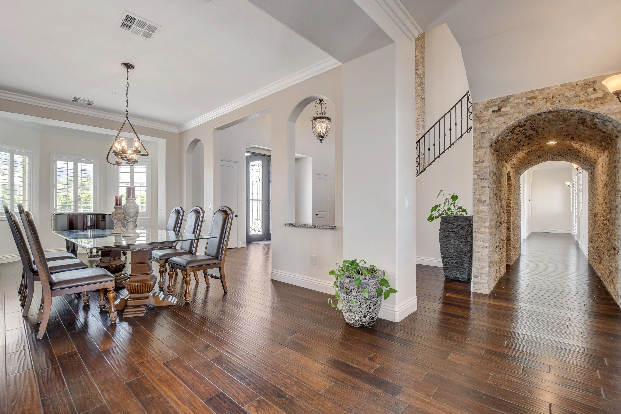 Formal dining room with long banquet table and baby grand piano at The Castle luxury vacation rental in Henderson near Las Vegas