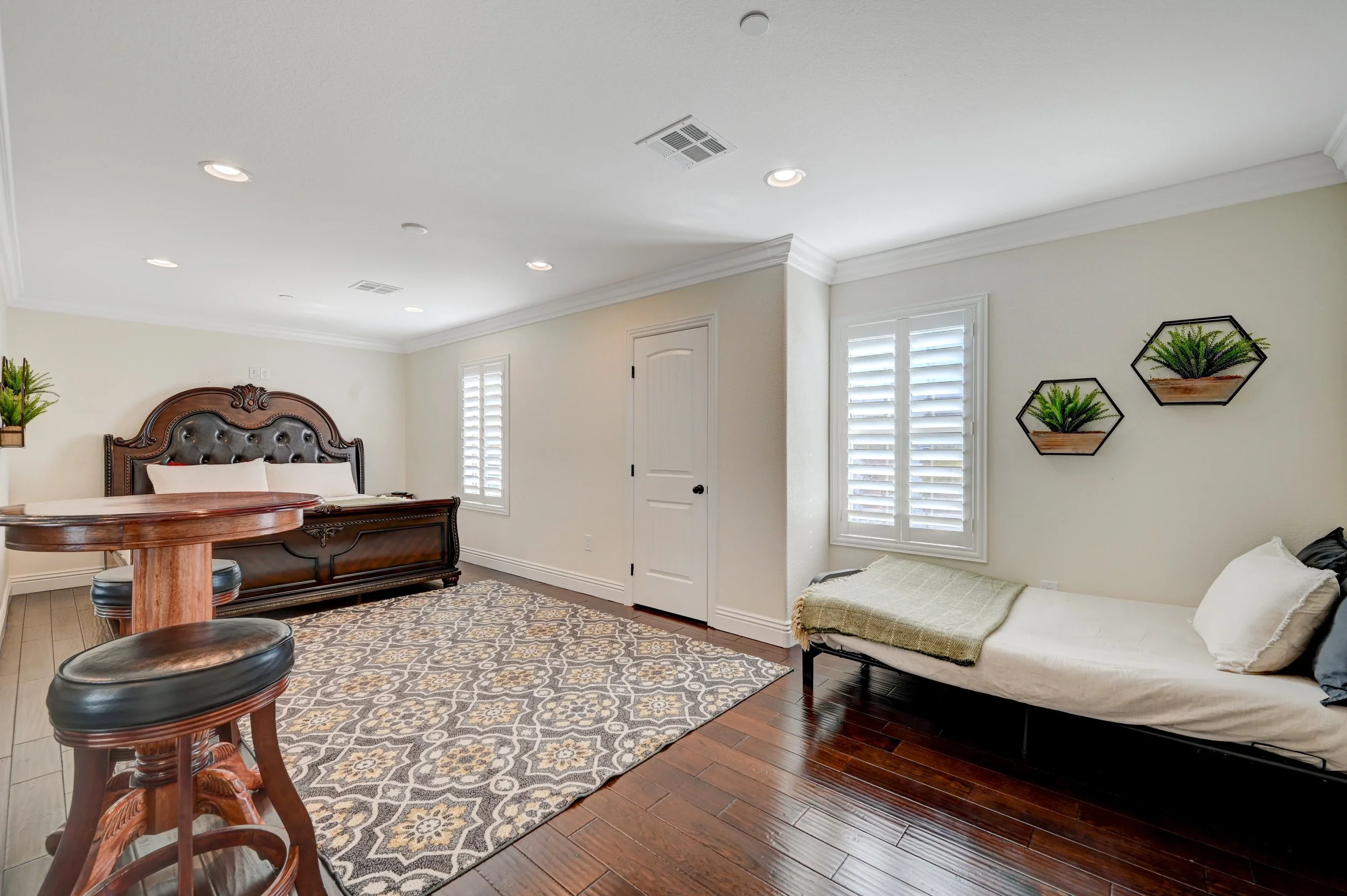 Guest bedroom with king bed, futon seating area, and pub table at The Castle luxury vacation rental in Henderson near Las Vega