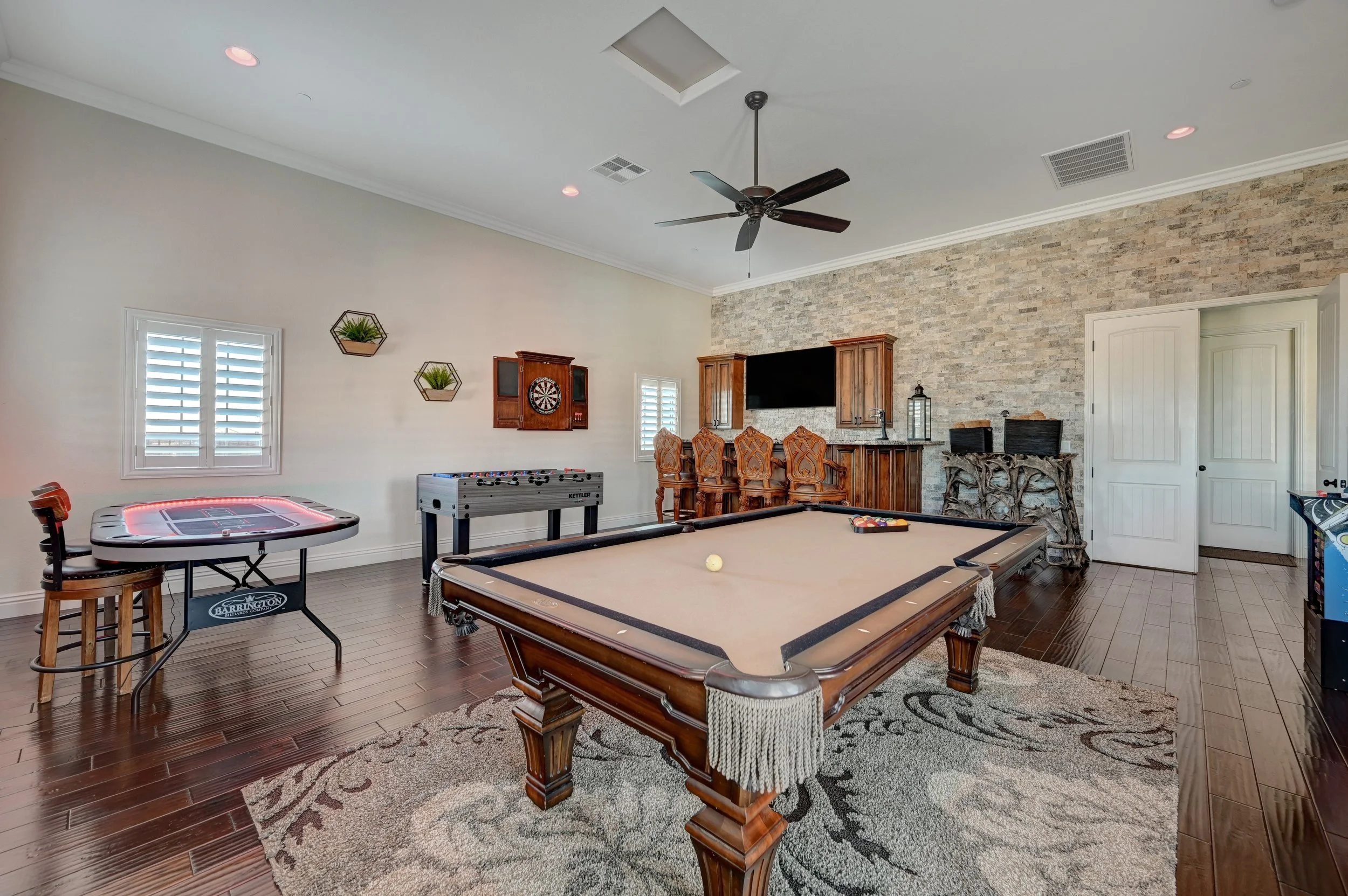 Private game room with billiards, poker table, arcade games, darts, and wet bar at The Castle vacation rental in Henderson near Las Vegas