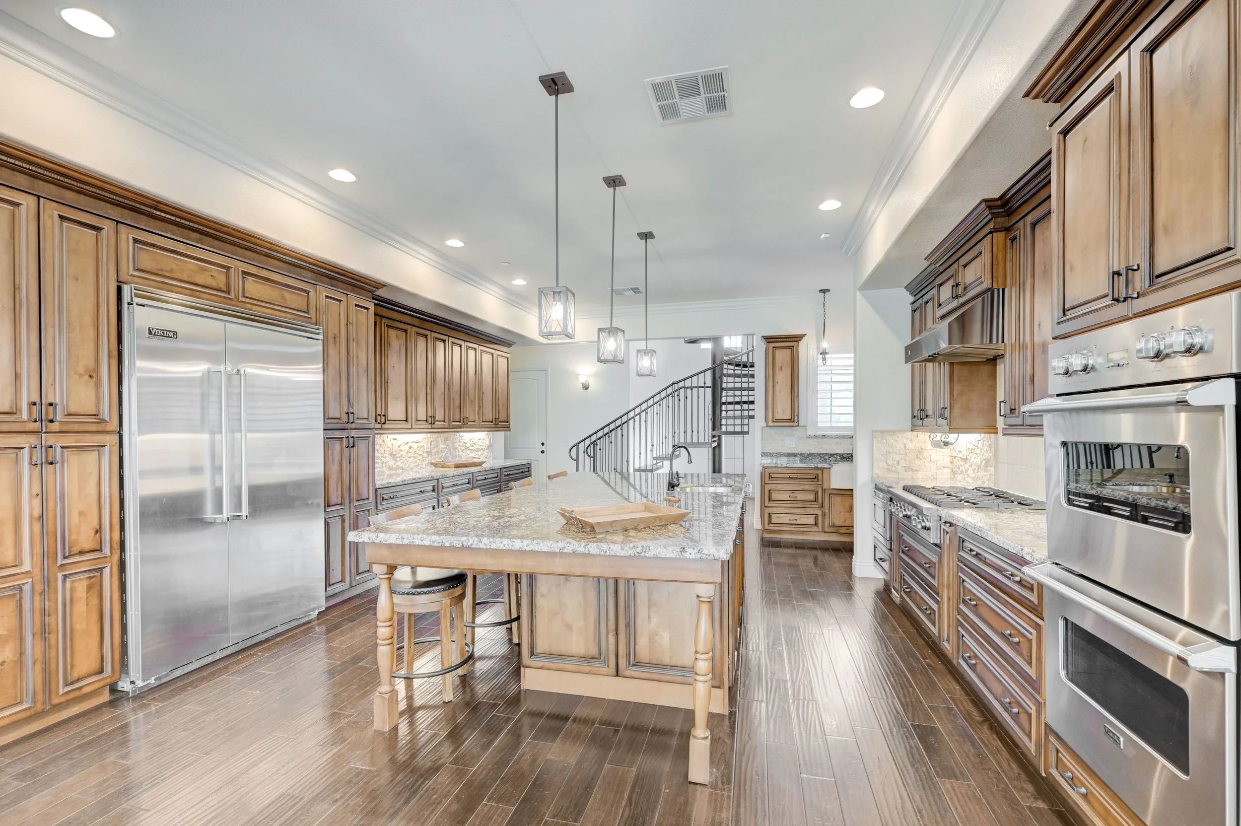 Open concept gourmet kitchen and living area with professional Viking appliances at The Castle luxury vacation rental in Henderson near Las Vegas