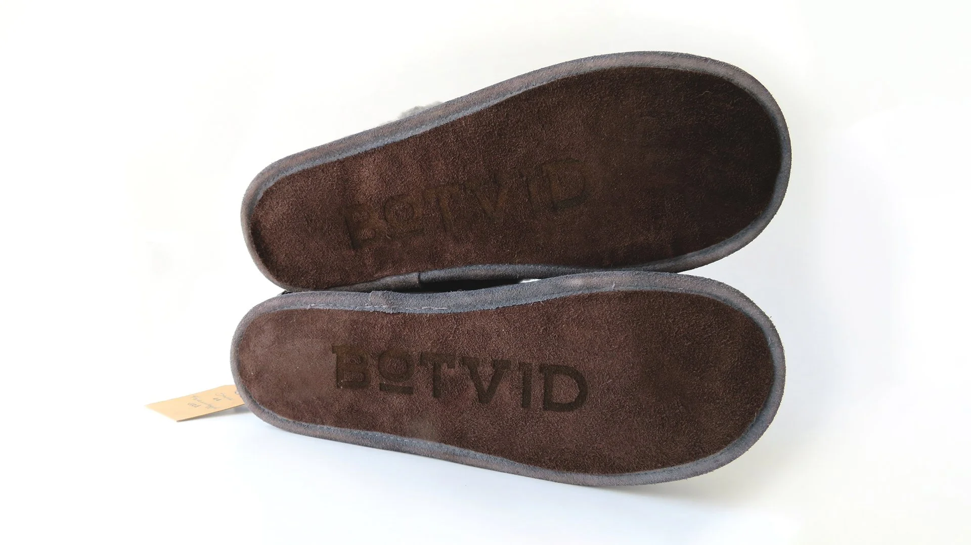 Botvid slipper product made from reclaimed leather, styled on a surface with logotype