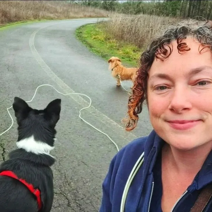 Sara the main trainer and owner of Barkasana Dog Training and Yoga Classes is outside smiling getting ready to train dogs with virtual dog training with Barkasana