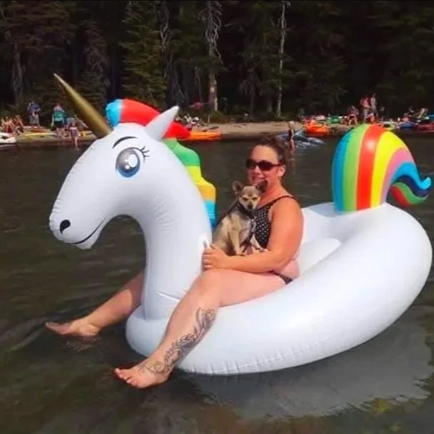 Sara the main trainer and owner of Barkasana Dog Training tubing at lake with a dog named Bhagwan the Chihuahua and getting ready to train dogs with virtual dog training with Barkasana. 