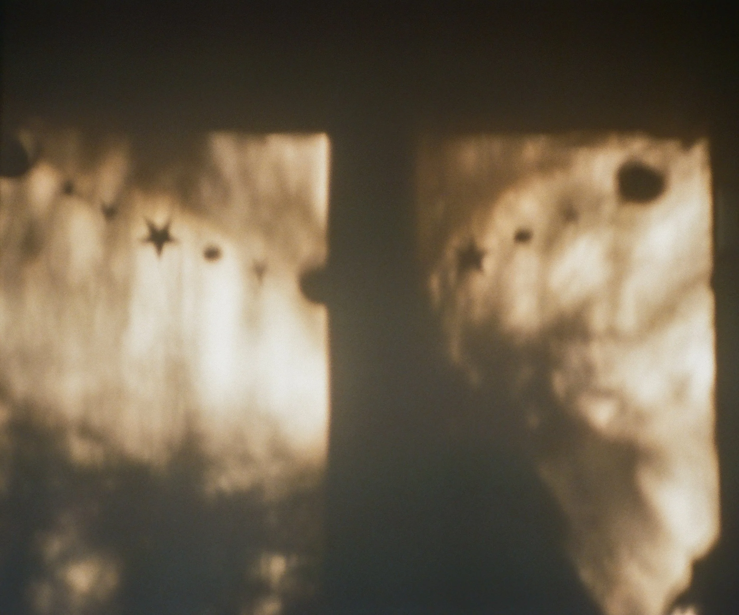 Shadowed profile of a young girl with curly hair looking at moonlit sky with clouds, stars, and the moon visible in the background.