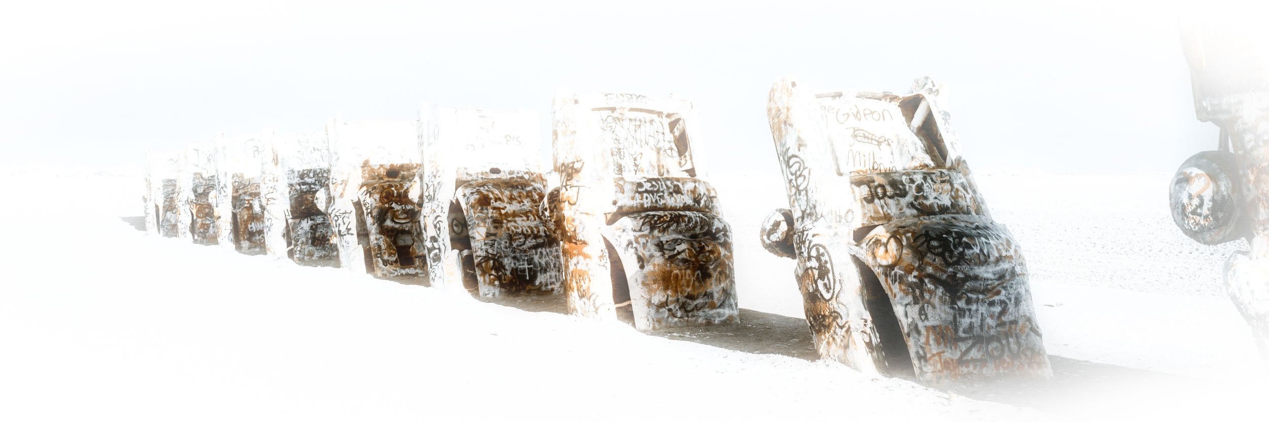 Ghosts of the Mother Road — Cadillac Ranch fades into a high-key realm of pure white light, the iconic sculptures rendered as ghostly apparitions.