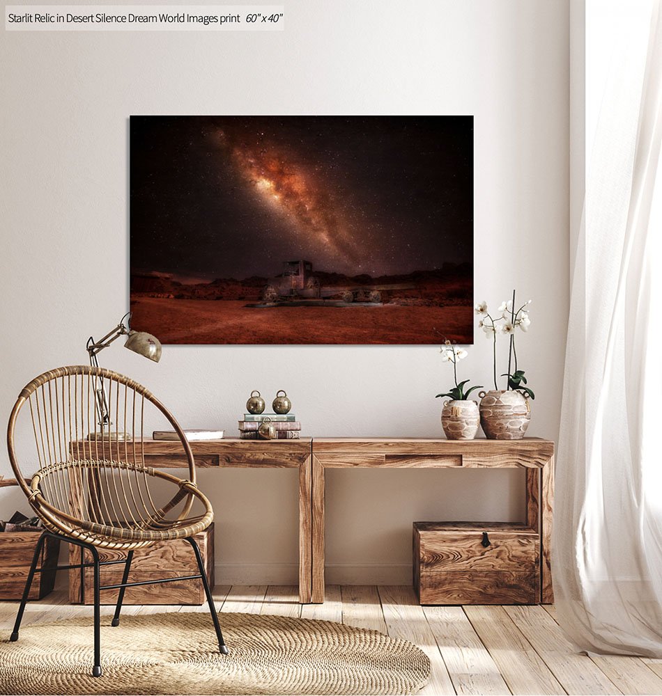 Night photo of the Milky Way over a desert landscape with an old vintage truck relic in the foreground under a star-filled sky.