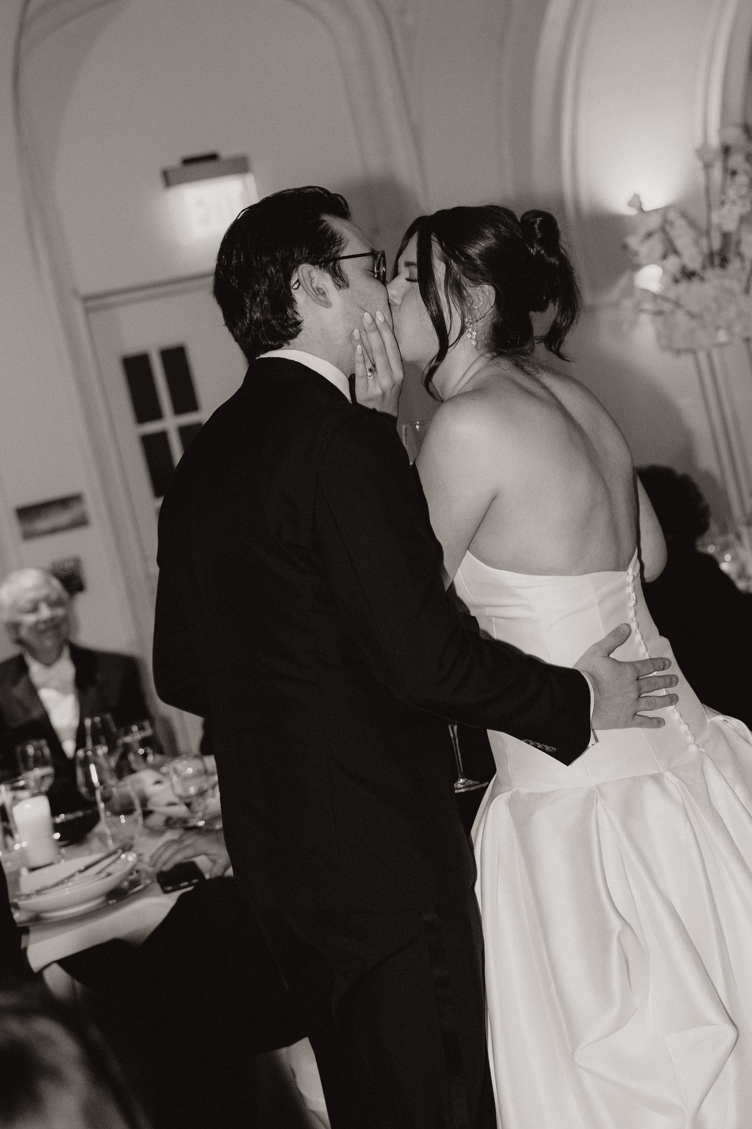 A bride and groom share a kiss at their wedding reception at the Kimpton Cottonwood Hotel in Omaha Nebraska. Omaha Nebraska Wedding Photographer