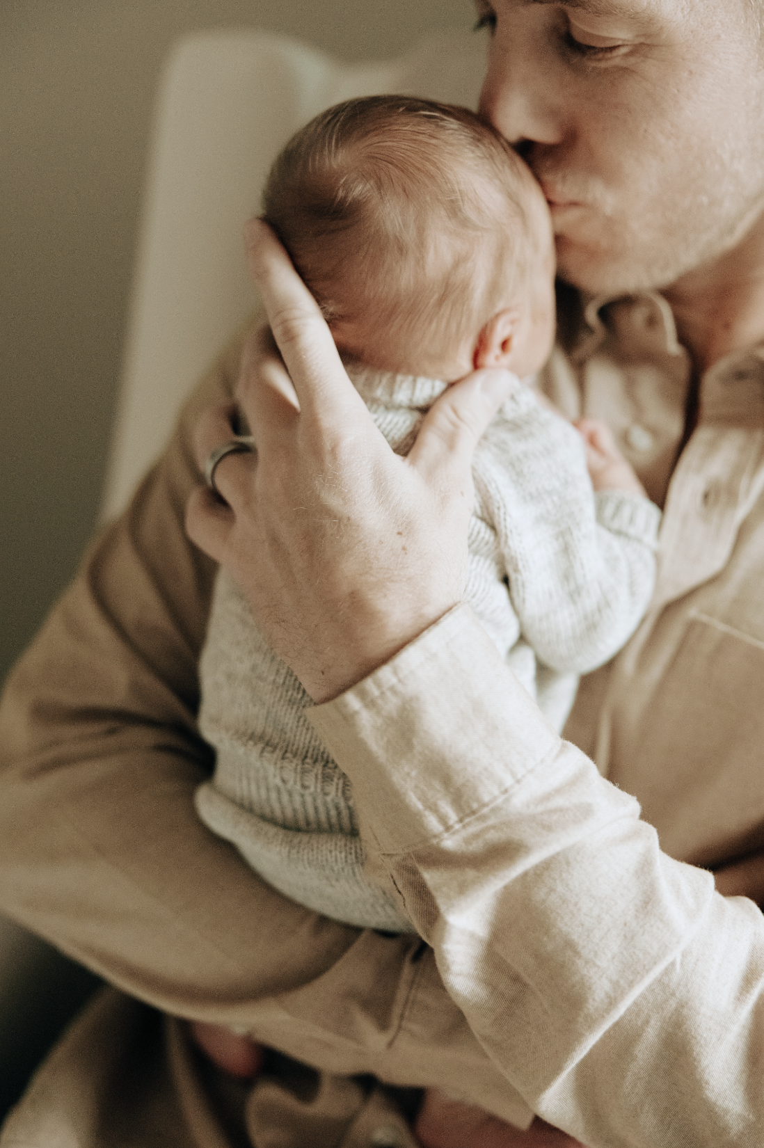 father kisses newborn baby. Katelyn Rowan Photography Omaha Nebraska Newborn and Lifestyle Photographer