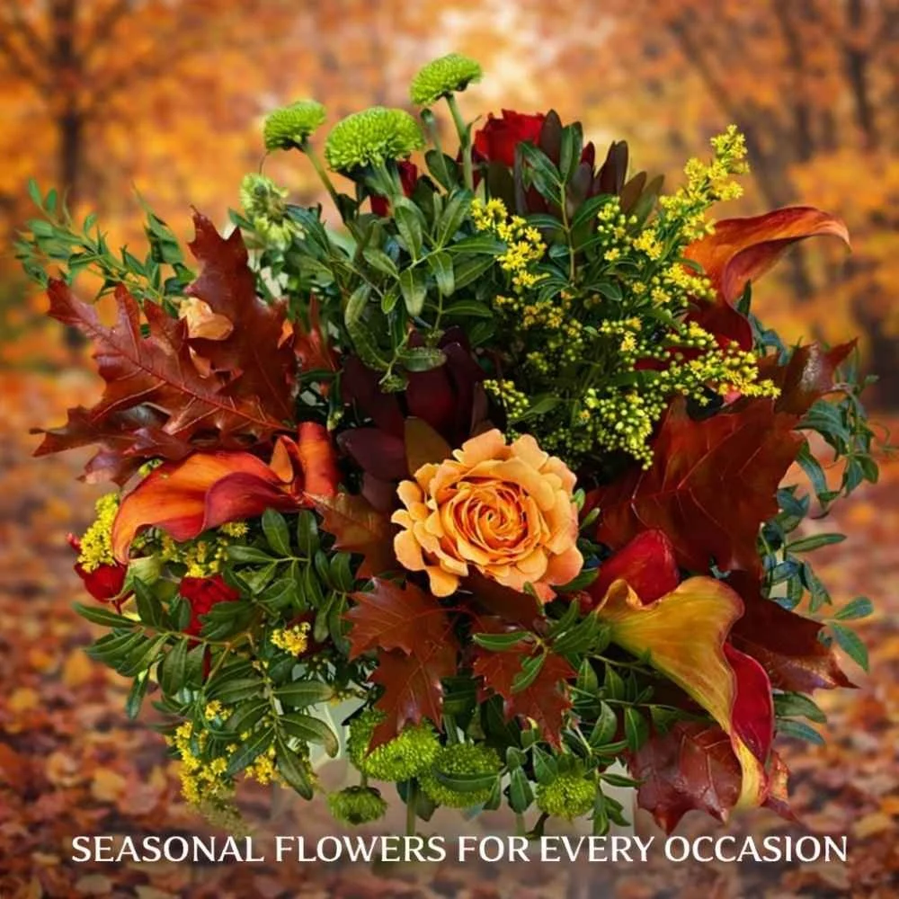 Bouquet of seasonal autumn coloured flowers and leaves