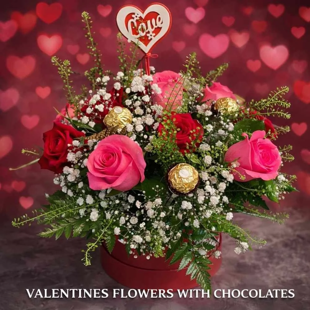 Valentines Flowers in a red hatbox with a love sign on top and chocolates as part of the design