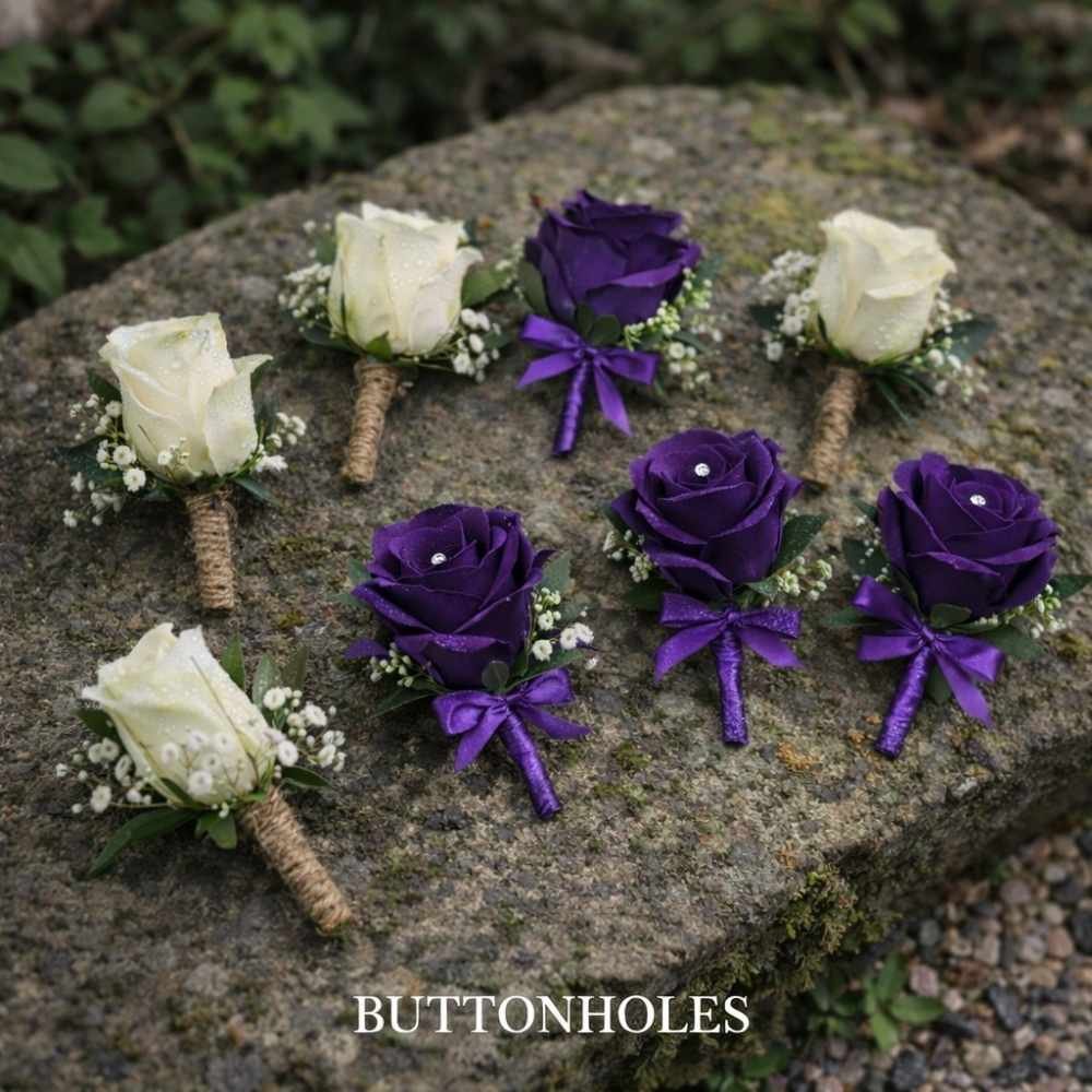 Buttonholes created for a funeral in cream flowers and different ones made of purple silk flowers