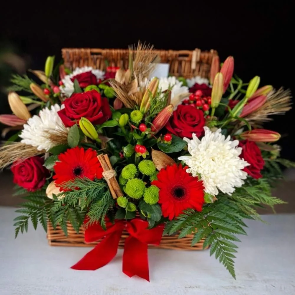 Red and cream Flowers beautifully arranged in a wicker hamper by Pasha Flowers