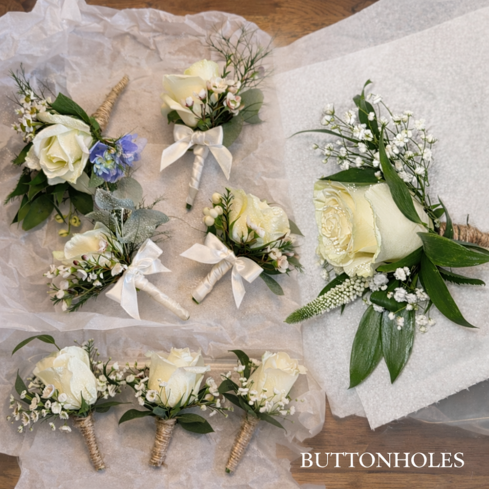 Buttonhole flower arrangements in cream roses