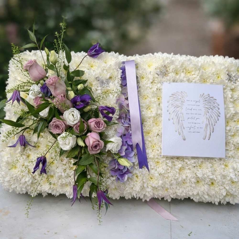 Funeral Flower arrangement in cream and purple flowers, in a design of a book