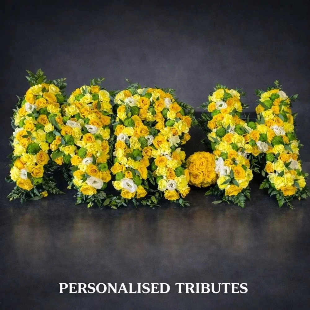 Personalised funeral flowers created in letters in yellow and white