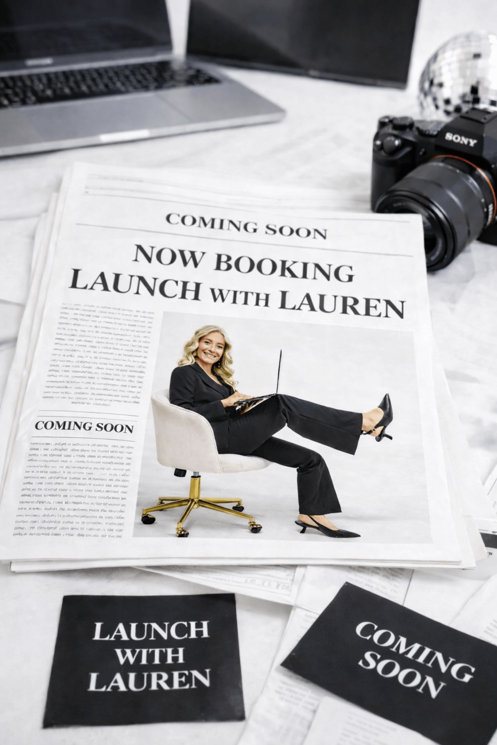 A newspaper announcing the launch of Lauren, featuring a woman in business attire sitting on a chair with her legs crossed, holding a laptop. The scene includes a camera, a silver disco ball, and a laptop on a white surface.