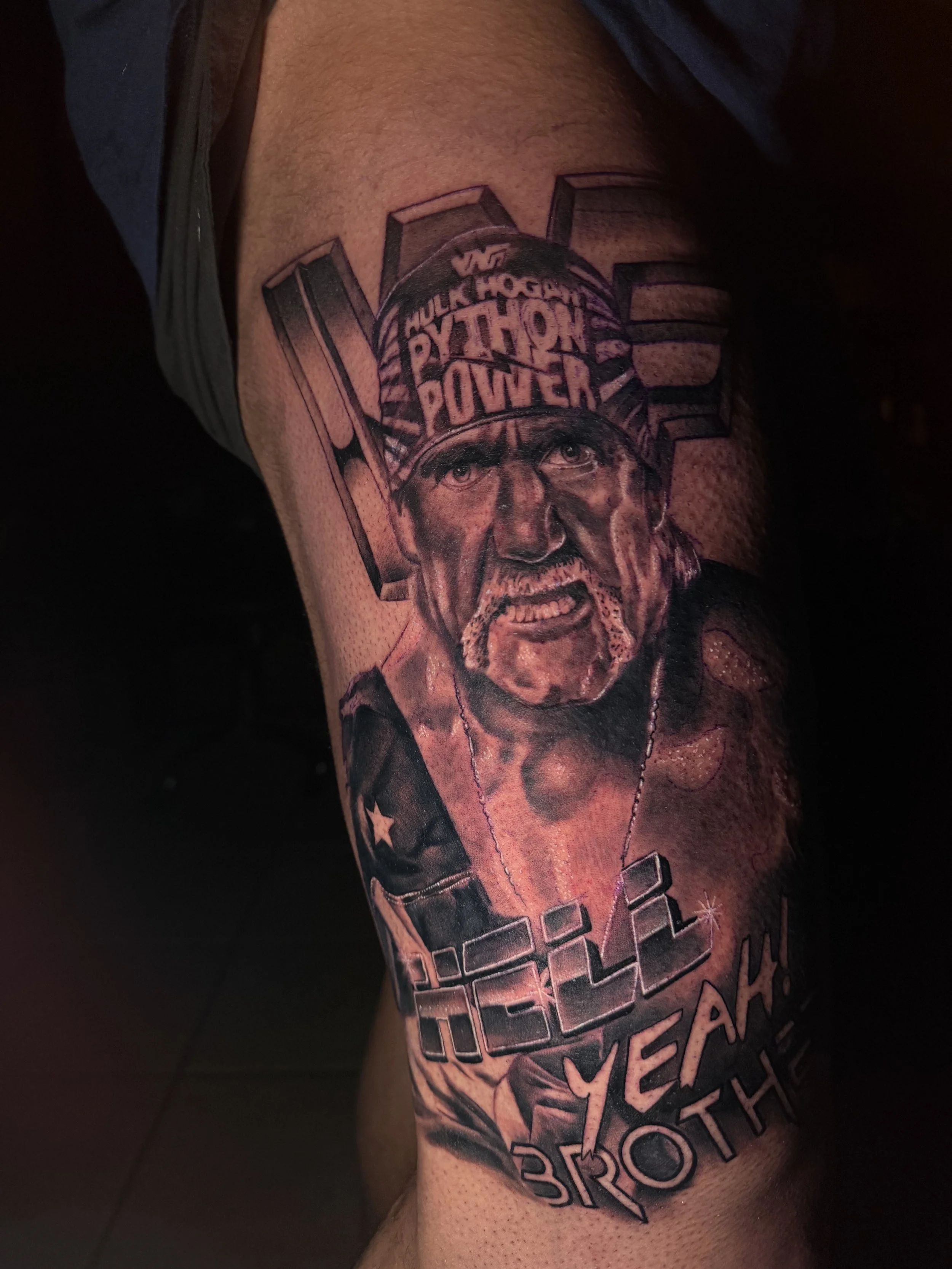 Tattoo of a man with a beard and mustache wearing a striped hat with the words "HULK HOGAN PYTHON POWER" on it, and the words "HULK YEAH BROTH" below.