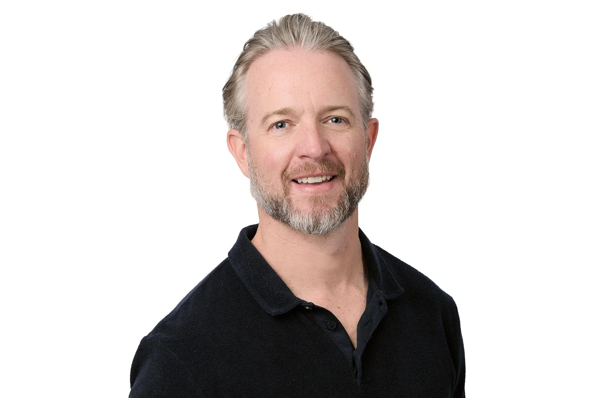 Headshot of white man in black polo