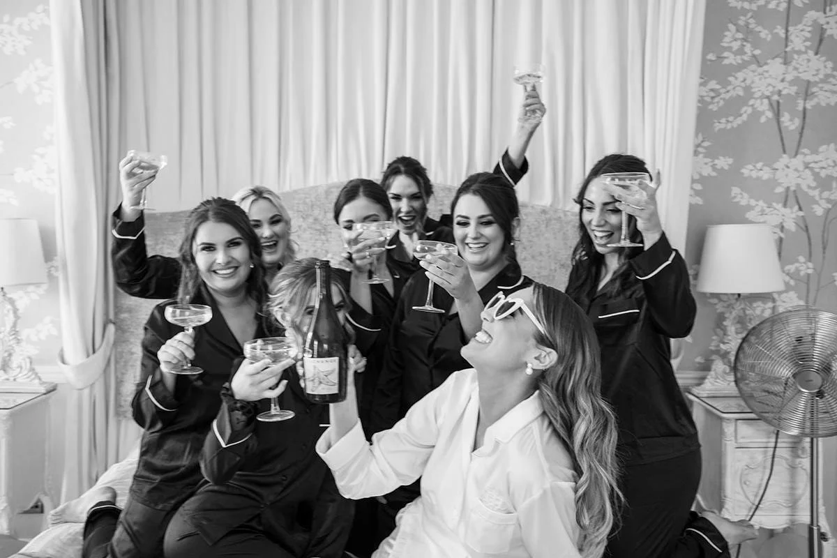 Bride and bridesmaids celebrating with champagne during bridal prep at Balbirnie House Hotel