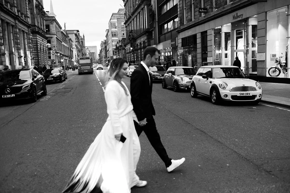 Couple walking hand in hand during a Glasgow city centre elopement, photographed by Glasgow wedding and elopement photographer Andy Hamilton.