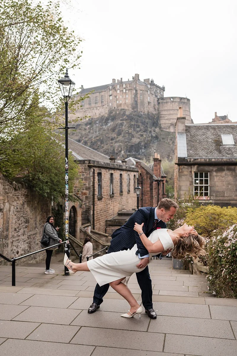 Wedding couple embracing on the Vennel Steps with Edinburgh Castle in the background