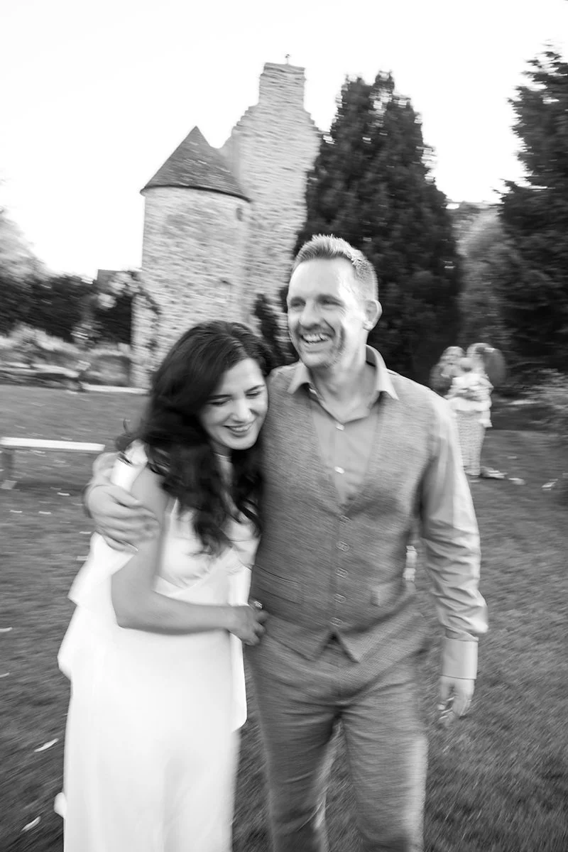 Candid moment of a couple laughing together during their wedding day