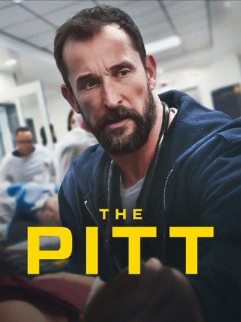 A man with dark hair and a beard, wearing a navy hoodie, has a serious expression. The background shows a hospital or medical setting. The text 'THE PITT' is overlaid in bold yellow letters.
