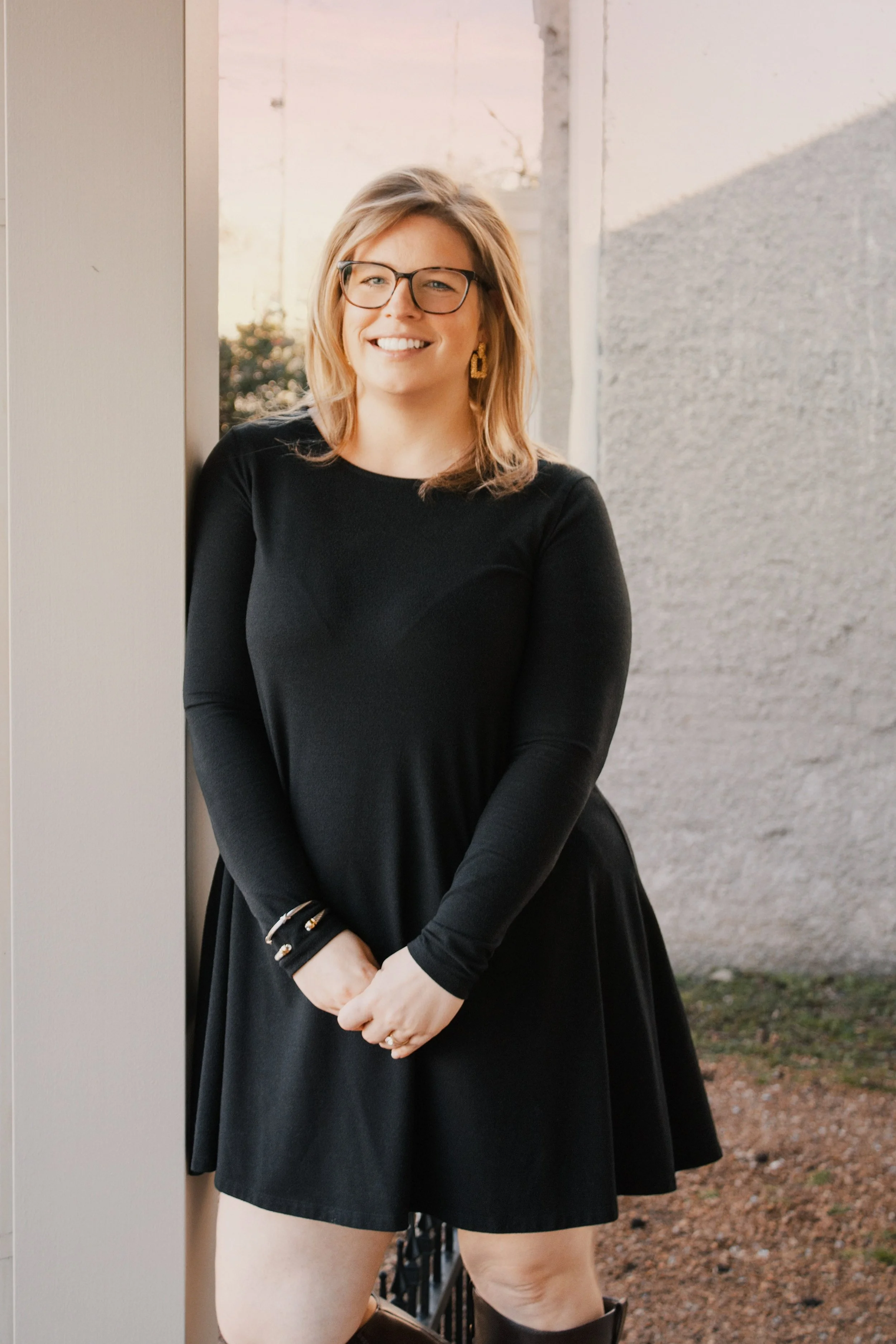 Allison Vega, A headshot of Allison Vega, Murfreesboro & Middle TN Real Estate Expert,  standing on the front porch