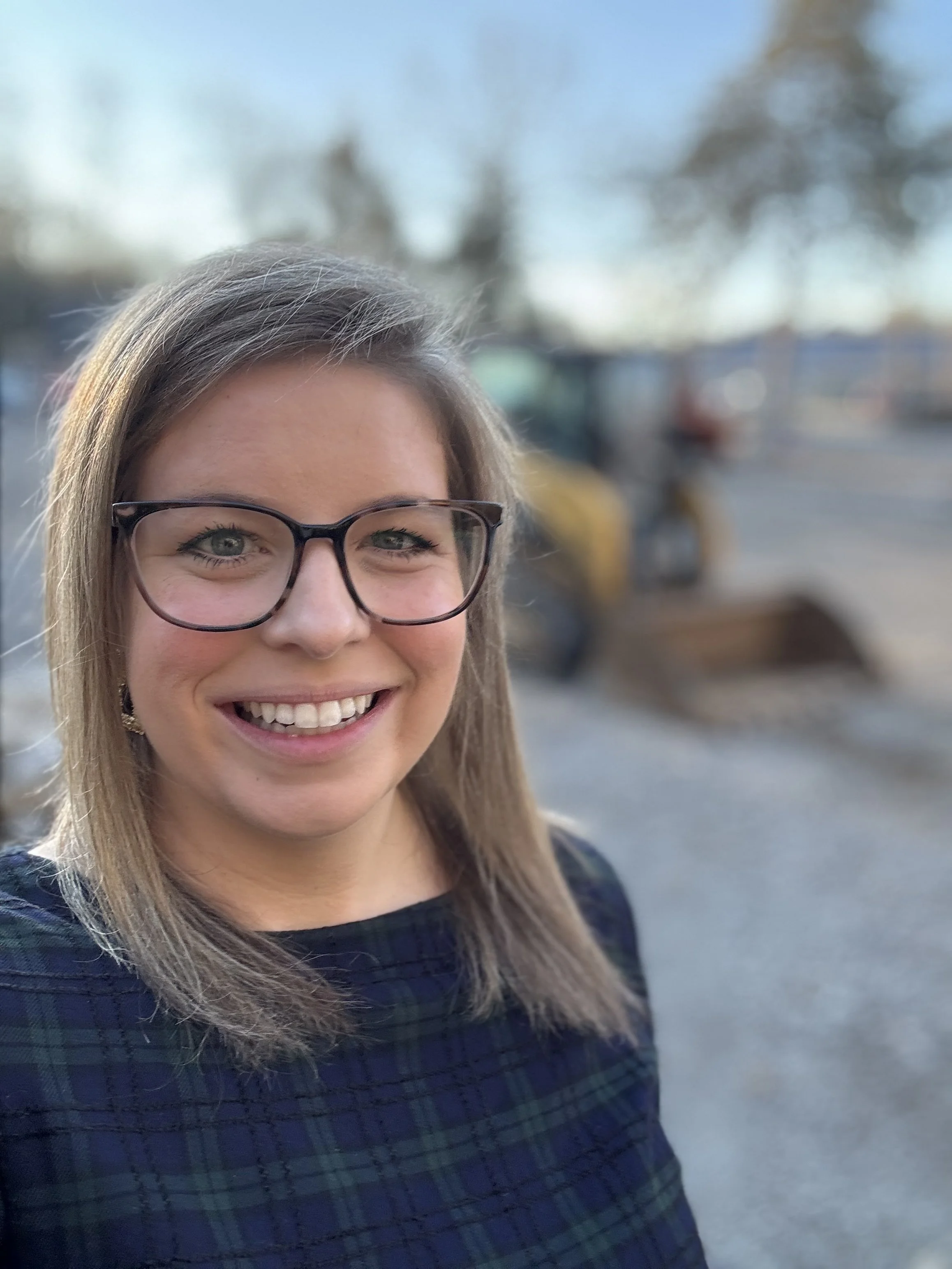 A headshot of Allison Vega, Murfreesboro & Middle TN Real Estate Expert, on a construction job site.