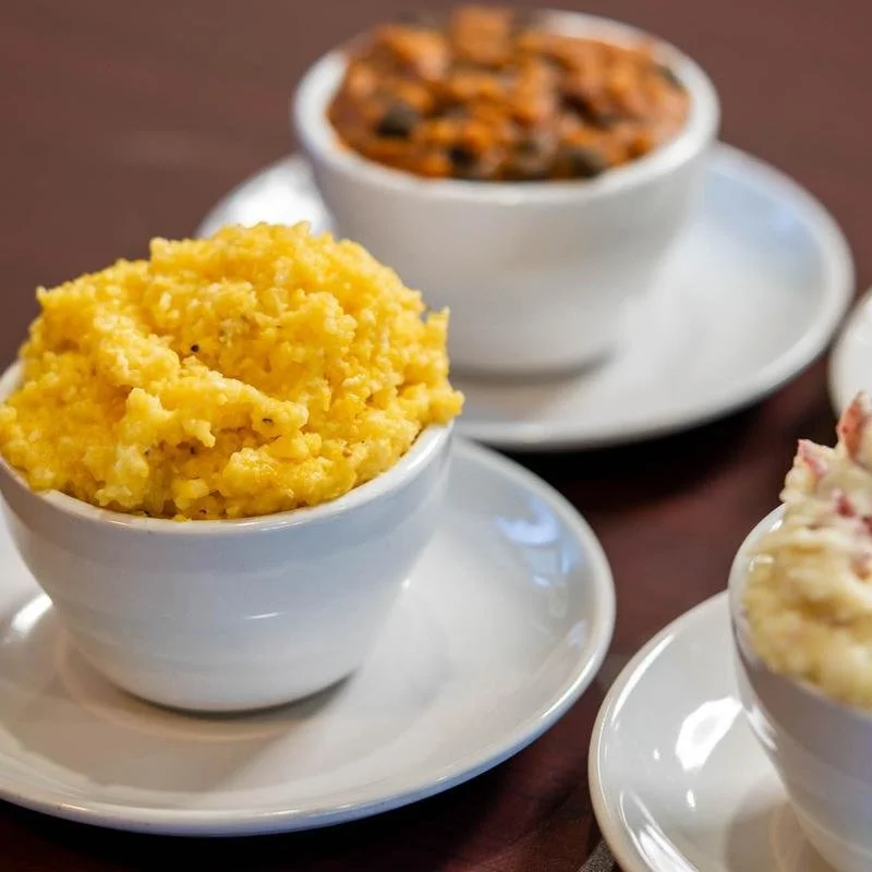 Bowls of mashed potatoes, baked beans, and potato salad.