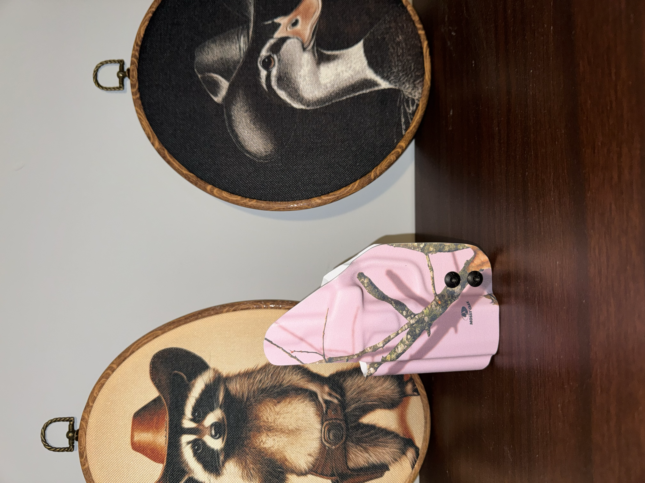 Two decorative baskets with animal illustrations, placed on a wooden surface. One basket features a dog, and the other appears to have a deer or similar animal. Both baskets have handles and are made of woven material.