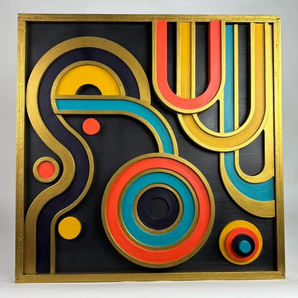 Colorful abstract geometric art with gold frame, black background, featuring circles, lines, and curves in red, yellow, blue, and black.