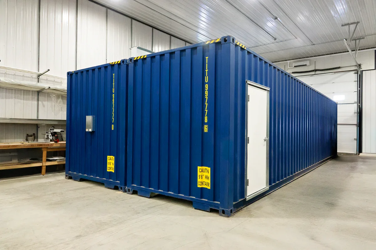 Double shipping container modified into one large container.