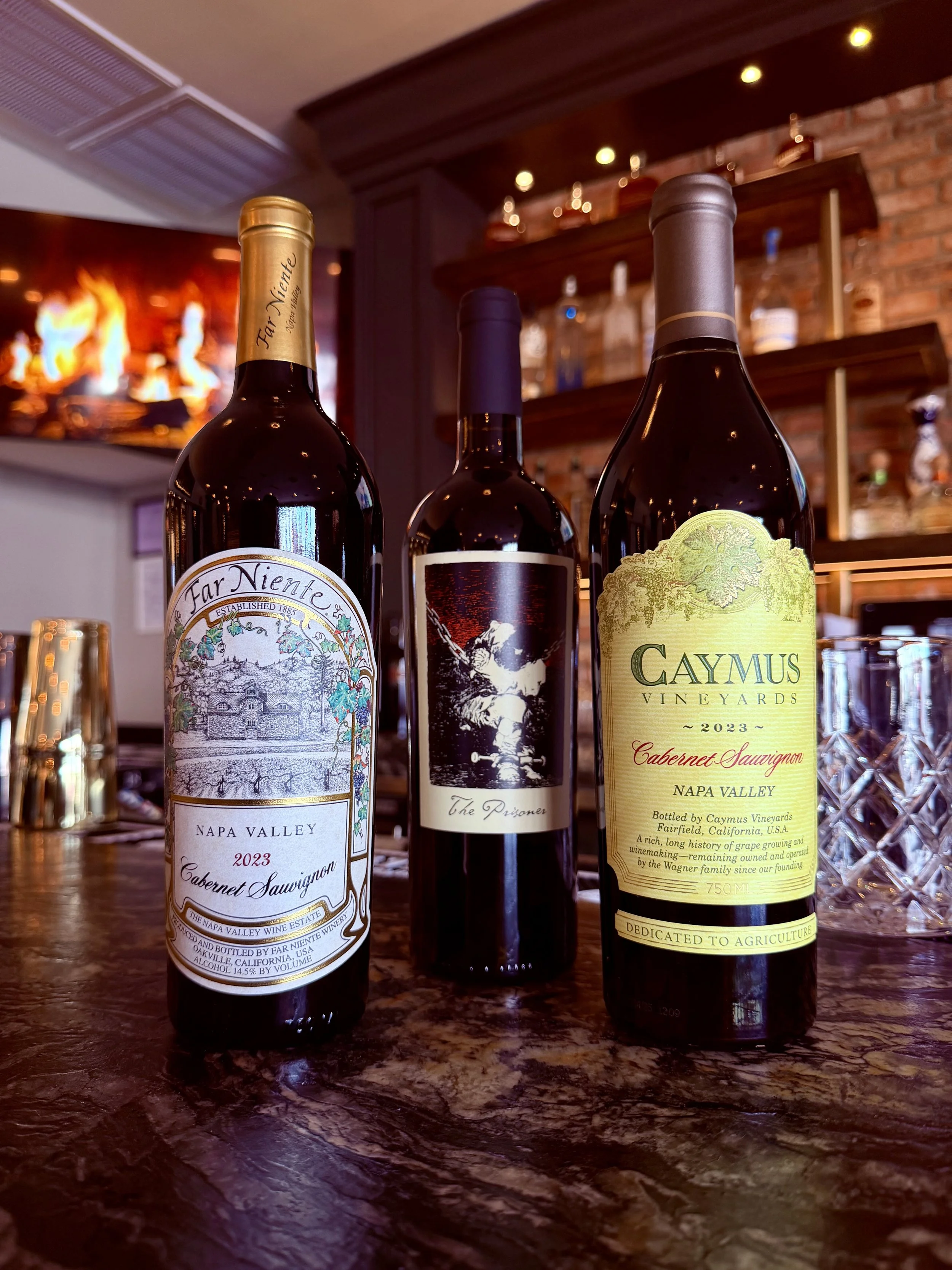 Caymus, Far Niente, and The Prisoner Cabernet Sauvignon bottles displayed at the bar in Duo Restaurant & Bar, Haddon Township, NJ