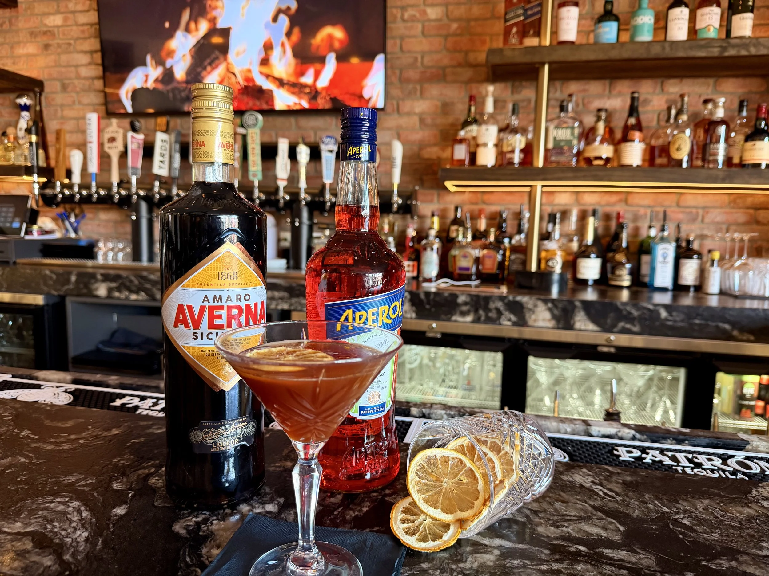 Paper Plane cocktail at Duo Restaurant & Bar in Haddon Township, NJ – bourbon, Aperol, Amaro, and dehydrated lemon in a chilled martini glass