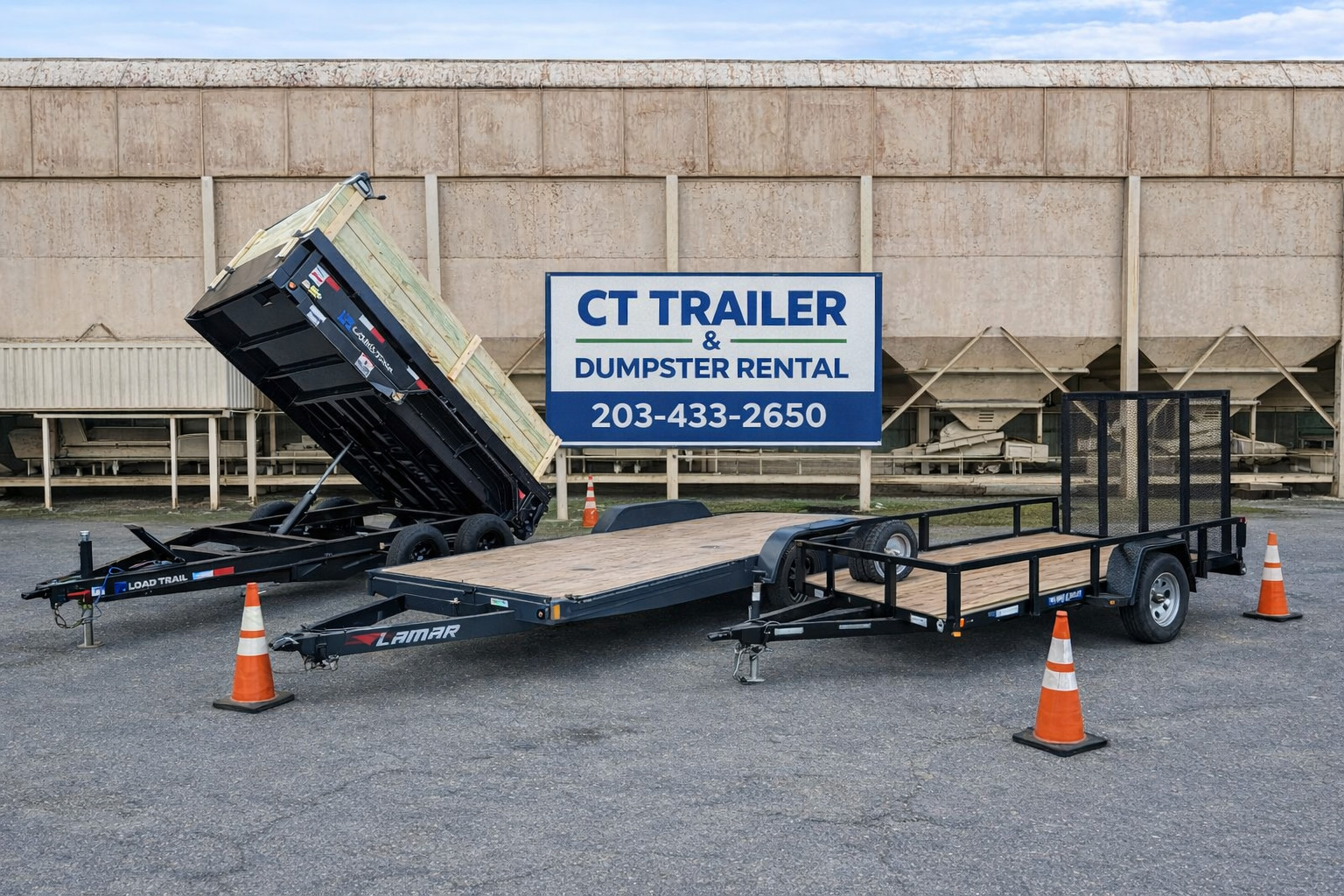 Two black utility trailers, one with a tilt bed raised, parked on asphalt in front of a sign for CT Trailer & Dumpster Rental, with orange traffic cones around them.