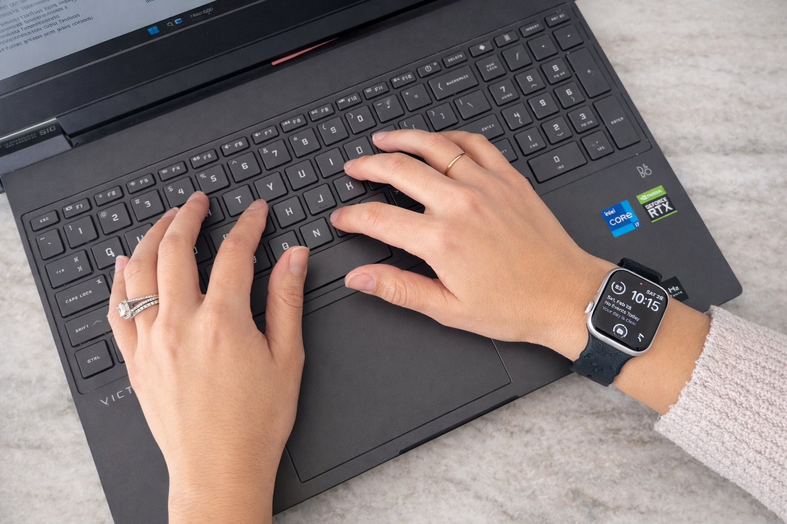 Marcie working on her laptop to custom design merchandise