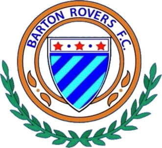 The badge of Barton Rovers Football Club featuring a shield, stars, diagonal stripes, and laurel leaves.