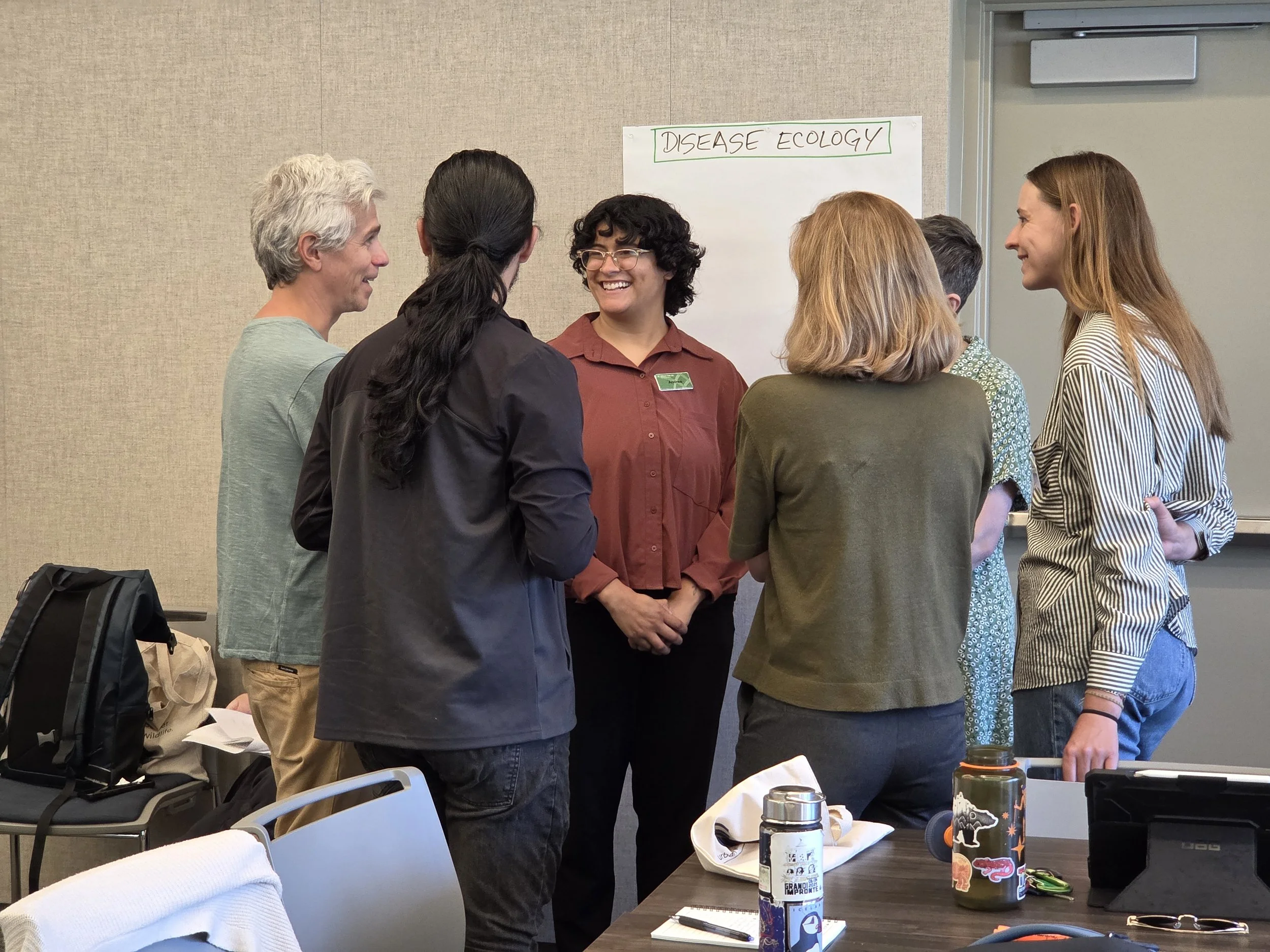 A group of wildlife scientists speaking about disease ecology