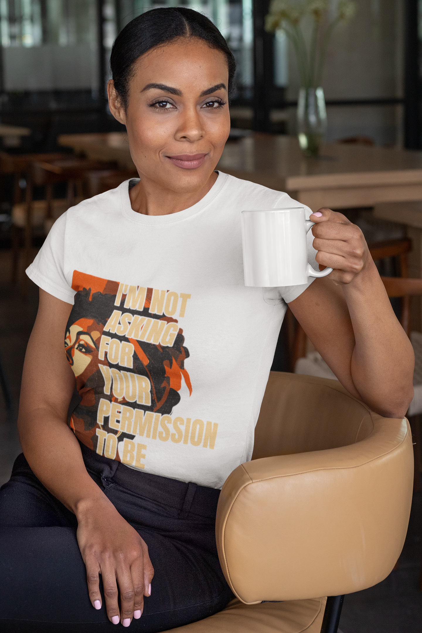 t-shirt-mockup-of-a-woman-sitting-on-a-chair-holding-an-11-oz-coffee-mug-31705.png